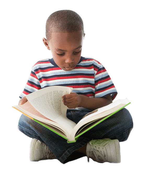 Young boy sitting, reading a book